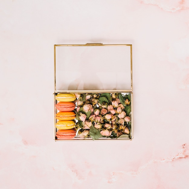 Box with flowers buds and cookies on light table