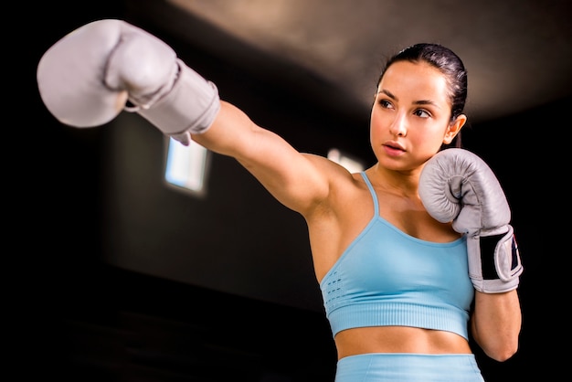 Boxer girl posing at the gym