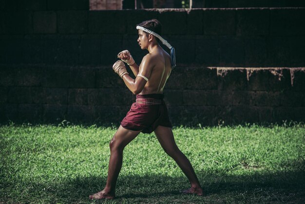 A boxer tied a rope in his hand and performed a fight, The martial arts of Muay Thai.