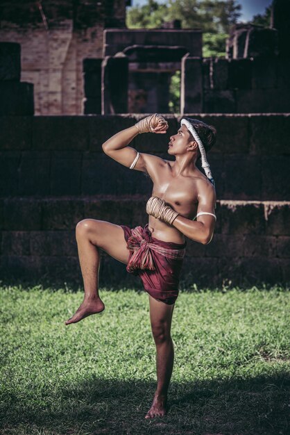 Free Photo a boxer tied a rope in his hand and performed a fight, the martial arts of muay thai.