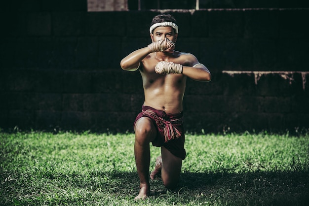 A boxer tied a rope in his hand and performed a fight, The martial arts of Muay Thai.