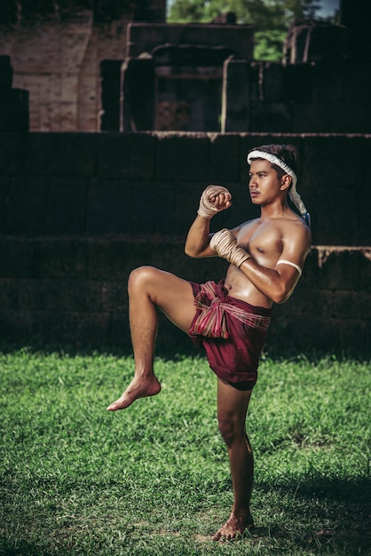 Free Photo a boxer tied a rope in his hand and performed a fight, the martial arts of muay thai.