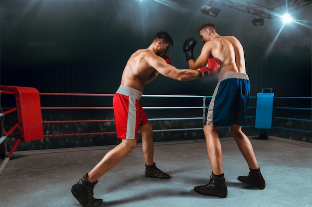 Boxers man fighting in ring