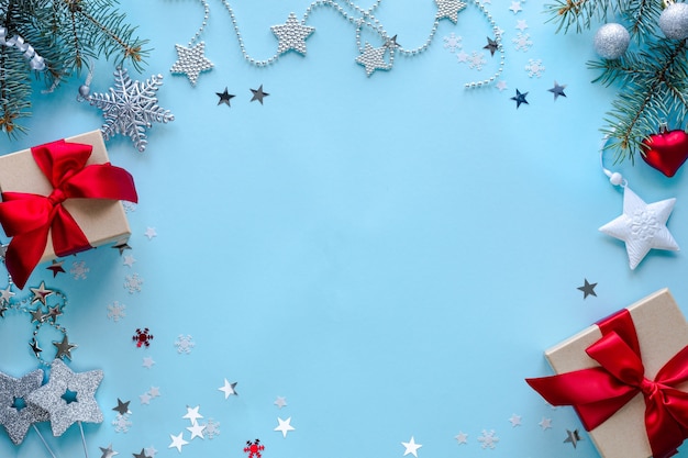 Boxes with gifts and Christmas decorations on blue surface