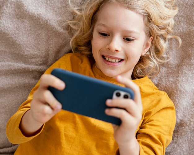 Boy in bed playing on mobile