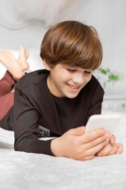 Boy in bedroom with phone