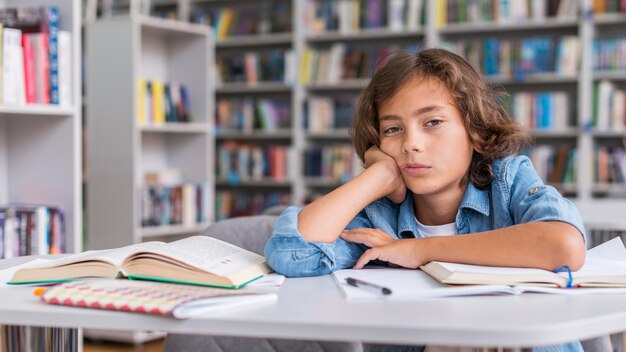 Boy being bored while he's doing his homework with copy space