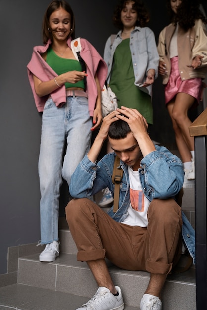 Boy being bullied on stairs full shot