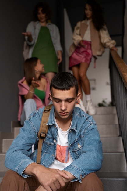 Boy being bullied on stairs low angle