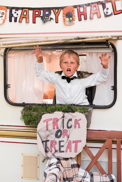 Boy being spooky with halloween sign