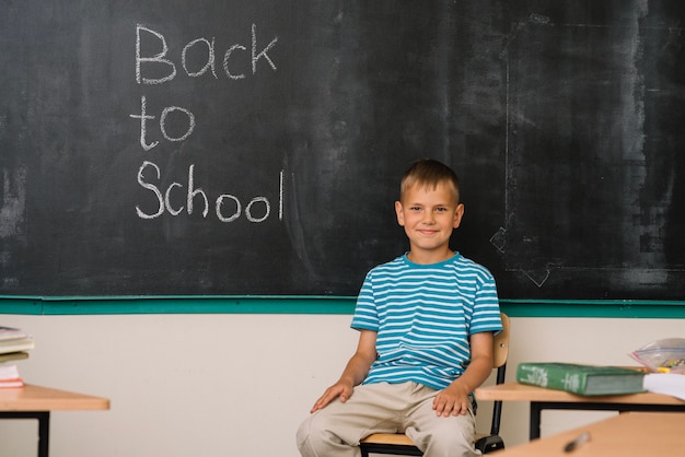 Free photo boy at blackboard in school