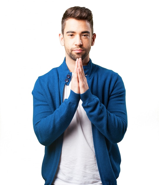 Boy in a blue jacket praying