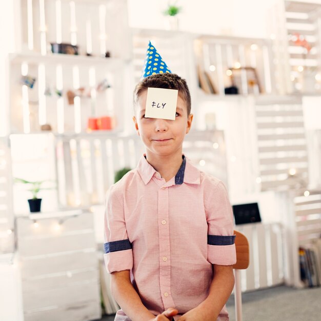 Boy in colored cap sitting