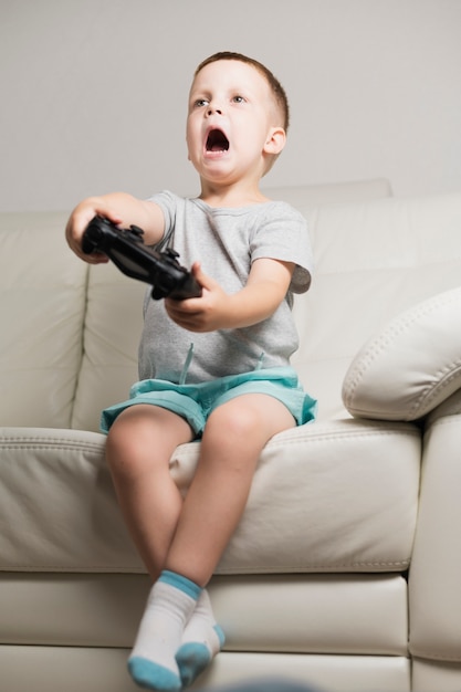 Boy on couch playing digital games