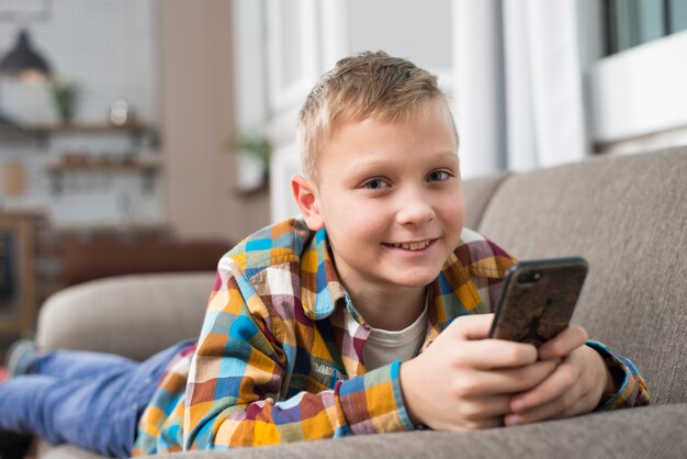 Boy on couch using smartphone