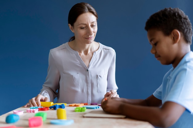 Boy doing a occupational therapy session with a psychologist