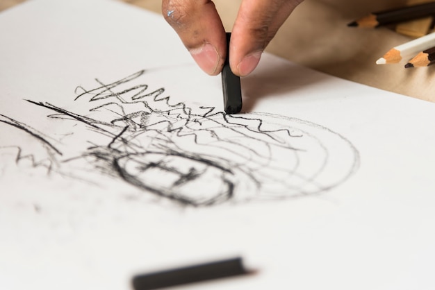 Boy drawing with charcoal