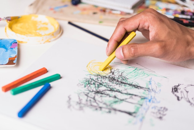 Boy drawing with crayon