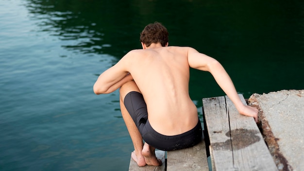 Free photo boy enjoying nature time in water