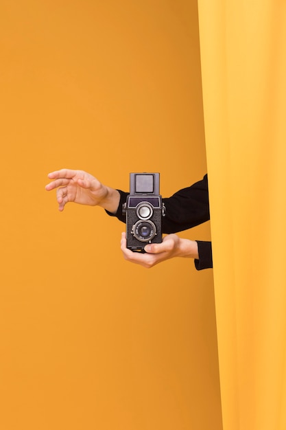 Free Photo boy filming with a camcorder in a yellow scene