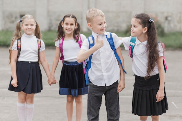 Free Photo boy gesturing thumb-up while standing near girl