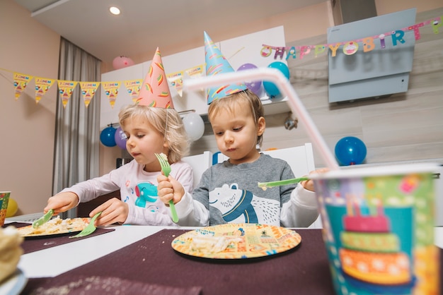 Boy and girl eating birthday cake