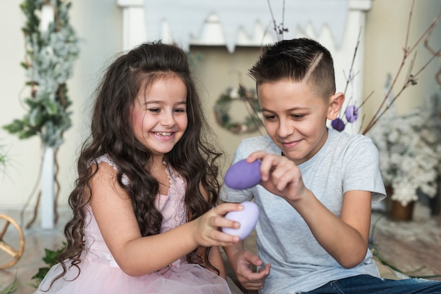 Boy and girl playing with Easter eggs