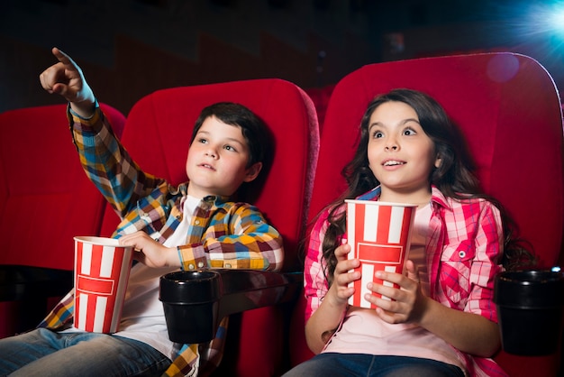 Boy and girl watching movie in cinema