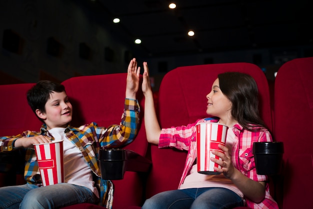 Boy and girl watching movie in cinema