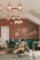 Free photo boy having coffee in a restaurant