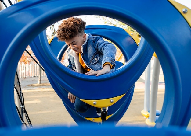 Free photo boy having fun at the playground outside