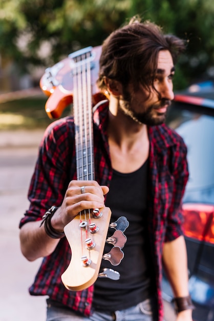 Free photo boy holding the electric guitar