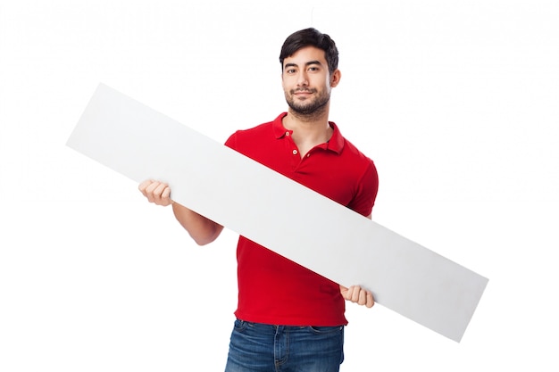 Free photo boy holding a large blank sign