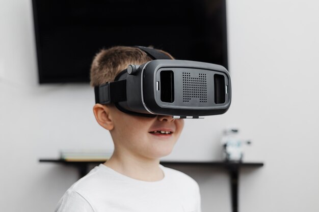 Boy at home using virtual reality headset