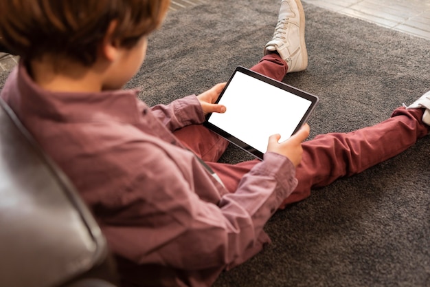 Boy at home with tablet