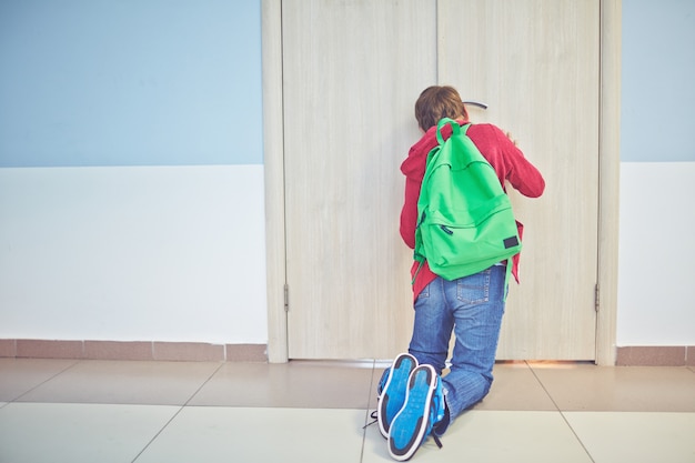 Boy kneeling on floor