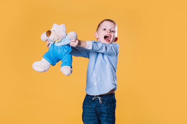 Free Photo boy laying with teddy bear