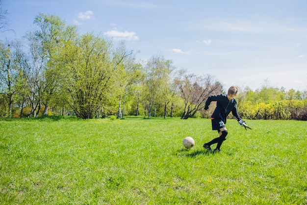 Free photo boy looking at the ball attentively