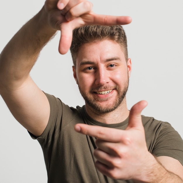 Free Photo boy making frame with the hands