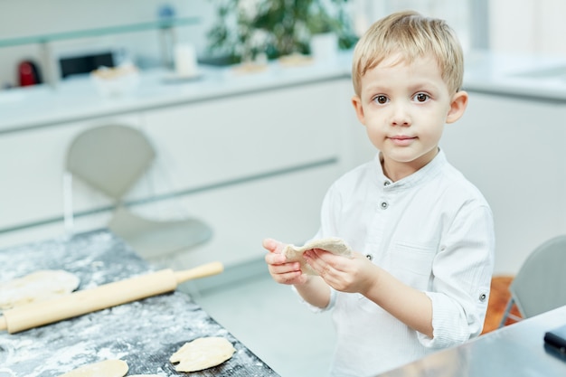 Free Photo boy making pastry