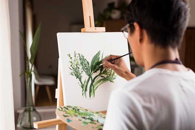 Boy painting on canvas