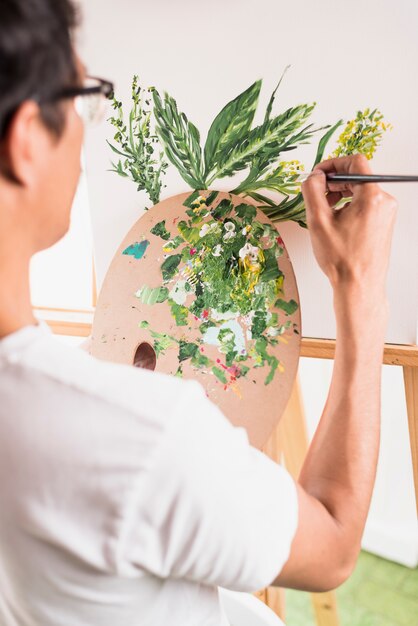 Boy painting on canvas