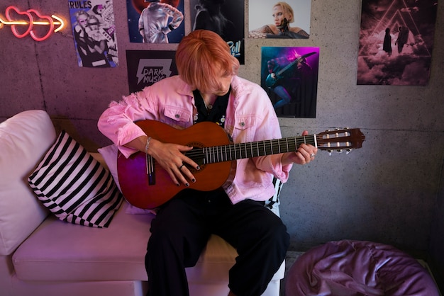 Free photo boy playing the guitar front view