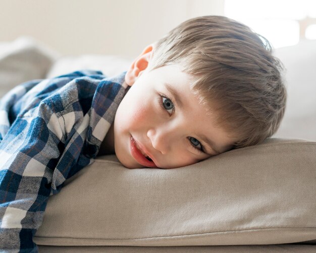 Boy playing on the sofa close-up