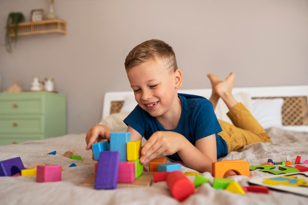 Free photo boy playing with brain teaser toys