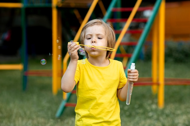 Boy playing with soap bubbles outdoor