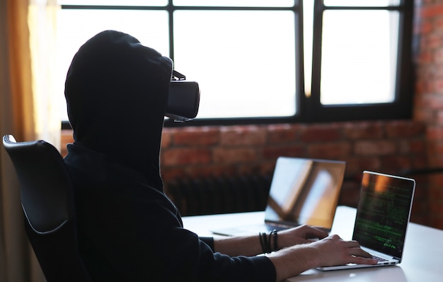 Boy playing with VR headset and laptop