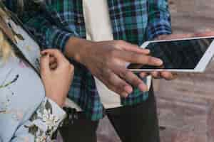 Free photo boy pointing at smartphone screen