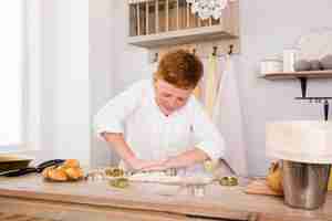 Free photo boy preparing a recipe in the kitchen