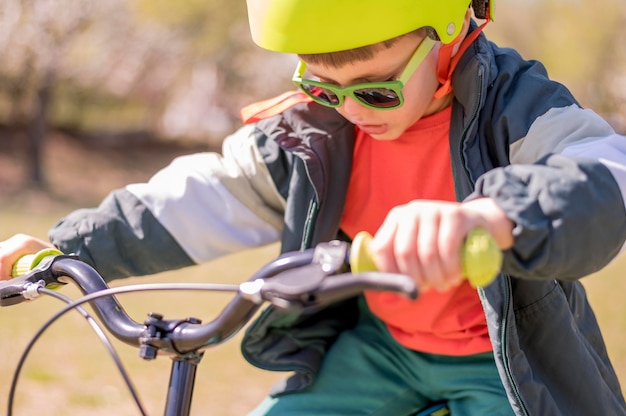 Free photo boy riding bicycle